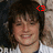 A pixelated portrait of a person with dark hair and a white shirt, featuring a red pixelated symbol on the right side of the head.