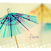 A static image of two paper umbrellas on a beach with a handwritten 'flora' text element.