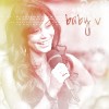 A pixelated image of a person with long brown hair holding a camera, with the text 'baby v' in the upper right corner.
