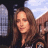 A 48x48 pixel buddy icon split into two sections: a left-side photo of a woman with long brown hair and right-side green text on dark background.