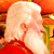 Static pixelated image of a bald character with white hair and red clothing against an orange background.