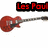 Two red electric guitars with black and silver details appear side-by-side under text reading "Les Paul" and "SG Gibson" in red pixelated font on a white background.