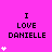 A bright pink background displays the text "I LOVE DANIELLE" in black pixelated font with white heart symbols appearing and disappearing around it.