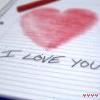 A static image shows a red heart drawn on lined notebook paper with handwritten text below it.