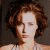 A pixelated image of a person with brown curly hair against a dark background, next to green text reading 'OriginalIcons.com' on a solid green backdrop.