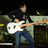 A pixelated image of a person playing an electric guitar on stage with green text reading "ROCK ON !!! <33" on the right side.
