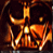 Static pixelated icon of a stylized orange-yellow figure with glowing limbs against dark background, resembling a cartoon character or mascot in motion.