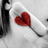 A grayscale image of a person's shoulder and neck with a red heart-shaped lip mark, paired with red text reading "Look after my heart — I've left it with you" on white background.
