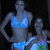 Two women in swimwear pose against a dark background; the right shows a grayed-out area replacing part of the scene