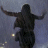 Two side-by-side frames of a low-resolution animated icon showing a dark silhouette figure with arms outstretched against a gray background, each frame containing small yellow light dots below the figure.