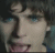 Animated sequence showing a person with dark hair and blue eyes, transitioning from static to heart symbols and text overlays.