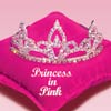 A silver tiara with clear gemstones rests on a pink fabric surface with 'Princess in Pink' text.