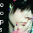 Pixelated close-up of a person with light skin and dark hair, wearing a pink garment, against a dark background with partial white text on the left.