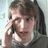 Pixelated image of a person with light brown hair holding a phone to their ear, next to blue pixelated text reading 'Charlie is so cool!! :)' and 'www.youtube.com' on a light background.