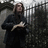A pixelated image shows a person in dark clothing holding an object near a fence, with red text on black background reading "do they that walls can hide you? even though I'm at your window, i am in the dark beside you. Joanna".