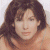 Static image of a person with brown hair against light background, next to green with pixelated text
