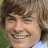 A pixelated image of a smiling person with light brown hair on the left, next to a red background with white text reading "I Love Zac Efron" on the right.