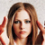 Pixelated image of a person with long brown hair, light skin, and dark eyes, wearing a red garment with visible shoulder straps.