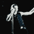 Animated sequence of a figure singing into a microphone with dynamic arm movements against a dark background.