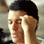 Static 50x50 pixel icon showing a close-up of a person with dark hair and light skin, partially obscured by motion blur or compression artifacts.