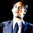 Pixelated static image of a person in formal attire with orange-brown hair against black background, rendered at 256x256 pixels.