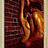 Golden curved shapes on a dark red textured background with light beige borders, appearing in two vertical