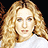 Pixelated image of a person with long curly blonde hair wearing a white top, next to bright pink text blocks on a gray background.