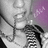 A grayscale anime-style icon with a purple background, featuring a character with dark hair and a visible necklace, partially cropped on the left side.