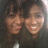 Two pixelated faces in close proximity, both smiling, with dark hair and light skin tones against a dark background.