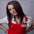 Two side-by-side frames of a pixelated animated icon showing a woman in different poses and backgrounds, one with red apron over white shirt against light gray background, the other with brown cap and green top against dark background.