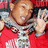 Pixelated image of a person in red clothing with silver chains, set against a bright yellow background with blue text.