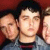A 50x50 pixel animated contact sheet showing two frames: a group photo of three people on the left and green text "Green Day" with a red heart on black background on the right.