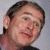 Static pixelated image of a person's face with dark hair, light skin tone, and neutral expression against gray background.
