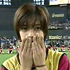 A person in a yellow and pink sports jersey covers their mouth with both hands in a stadium setting, transitioning to other hand positions and facial expressions.