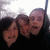 Three pixelated faces in close proximity against a dark background with light gradient above.