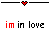 Pixelated icon with red and black text 'im in love' and heart symbols above, showing animation where 'im' and 'love' change color between frames.