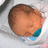 A pixelated image of a sleeping baby in a white blanket with blue accents, next to a green background with blue text reading "I Love My Nephew".