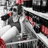 A static pixelated image shows a figure in a white outfit with red accents against a black-and-white background.