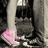 A split-screen image with a grayscale photo of legs in pink shoes on the top-left, bright magenta containing pixelated text, and a gray