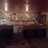 Pixelated static image showing blurred interior with warm lighting and indistinct shapes suggesting furniture or architectural elements.