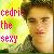 Pixelated image with text 'Godric The Sexy' in red and brown letters on a yellow-green gradient background, featuring a person's face.