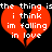 Two identical red broken hearts with white text on black background, each heart split into two pieces with text reading "the thing is i think im falling in love".