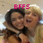 Two people embrace in a close-up pose with one person kissing the other's cheek, overlaid with pink pixelated text reading BFFS.