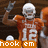 Pixelated image of a football player in an orange uniform with number 12, holding a football and raising one arm, standing on a field with 'hook em' text below.