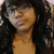 A person with long dark hair and bangs appears in a of three , the bottom-right is blank
