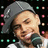 Pixelated image of a person wearing a gray cap and white shirt holding a microphone against a dark background with colored dots, with purple text overlays.
