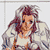 Pixelated image of a person with long brown hair wearing a white top and light-colored jacket, set against a plain background.