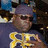 Pixelated image of a person wearing a purple cap and sunglasses with yellow text reading "Do Work Son" on a black background.