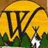 A pixelated icon shows a large yellow circular shape with dark brown structural lines, green foliage below, and a white cross-like object on the right.