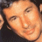 A pixelated image split into two sections: a person's face on the left and green text on a dark background on the right.